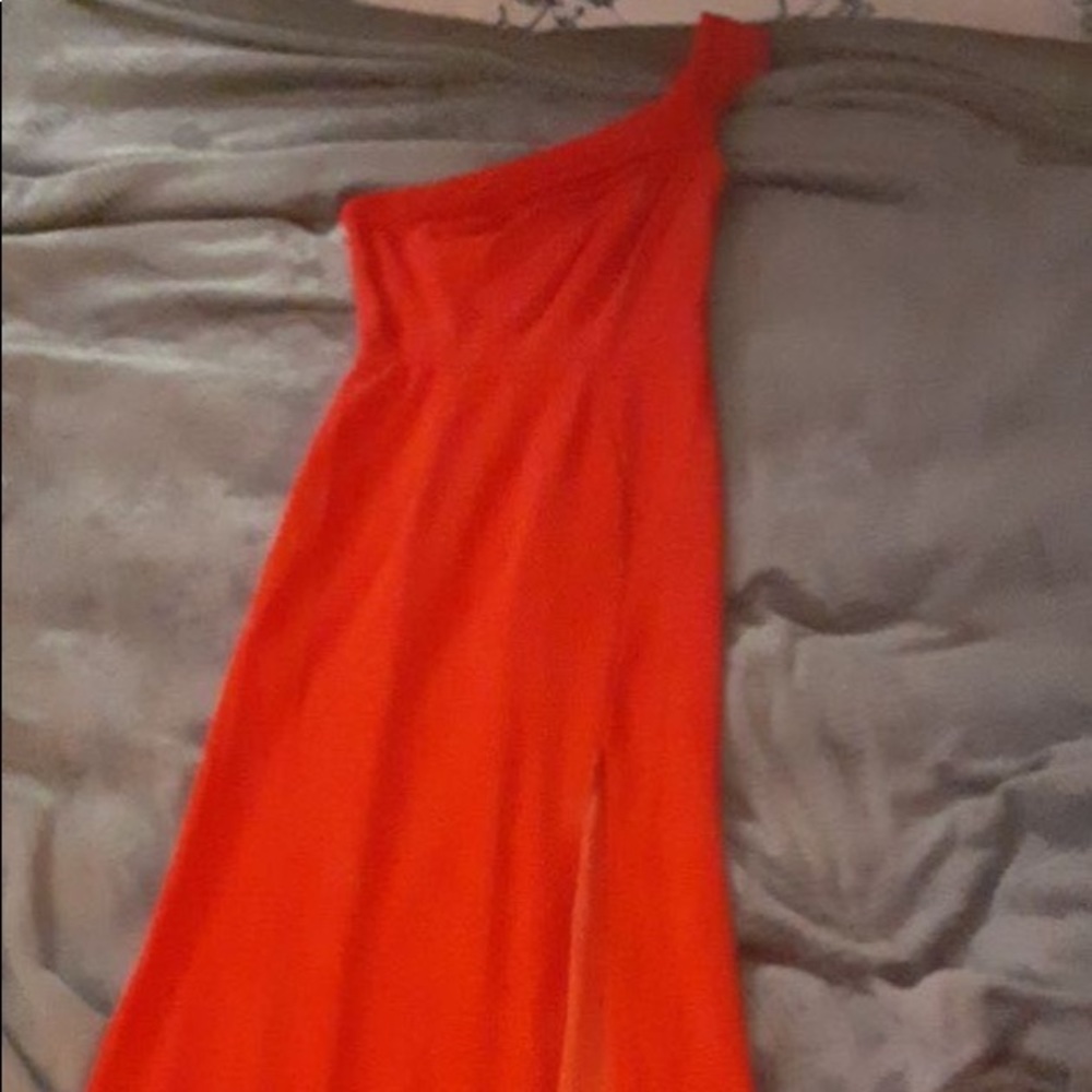 I’m selling this brides maid dress it’s red split down the leg, cut off in back